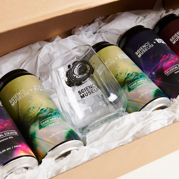 Cans of beer and a glass, all with space-themed artwork