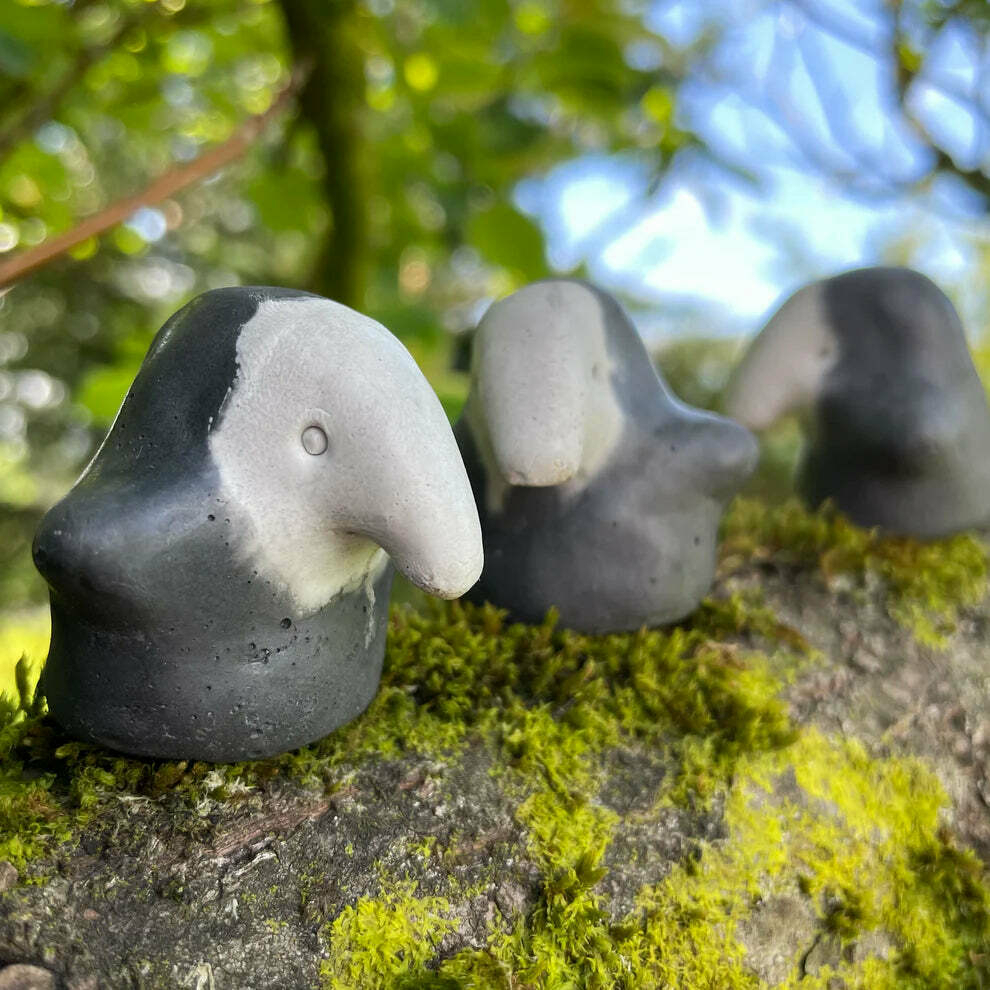 Two-tone stone worry dolls in the shape of little creatures