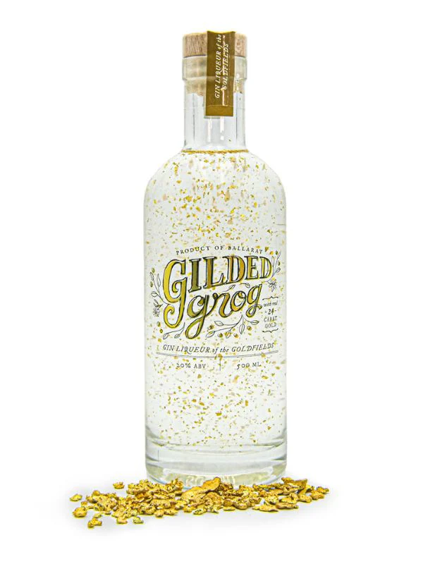 A bottle of clear liqueur with gold leaf suspended in it